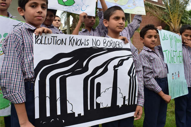 Schoolchildren in India hold up posters about climate change 