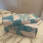 A two wrapped presents on a marble surface  Description automatically generated