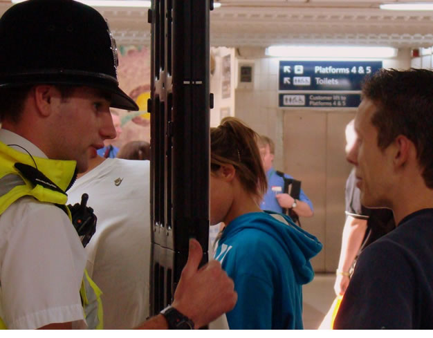 Police officer explains knife arch to member of public