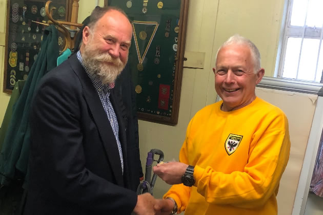 Jon Leech, president of Wimbledon Park Rifle Club, (left) presenting a medal to competitor Keith Ealey (right).