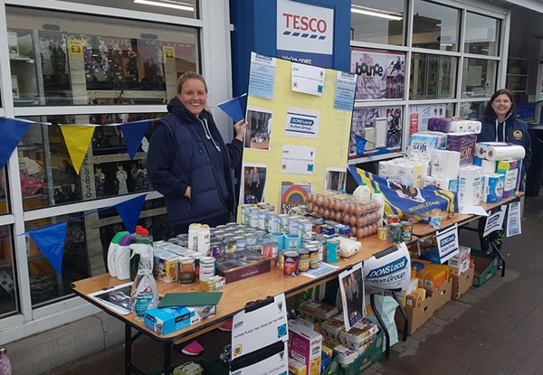 Dons local action group at food donation stall