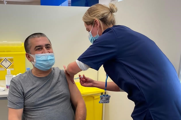 A man gets his Covid-19 vaccination at Centre Court shopping centre in Wimbledon. Credit: SWLCCG